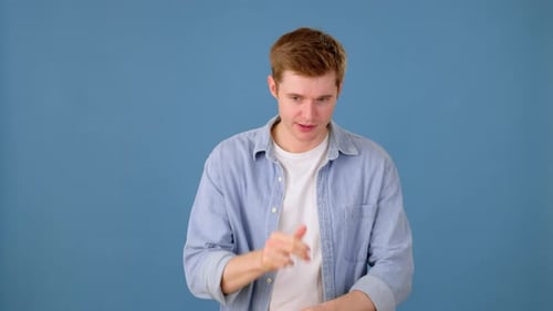 Concerned Young Man Thinking and Feeling Nervous in Studio