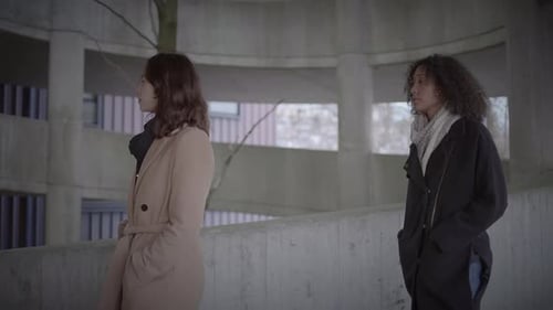 Lifestyle Portrait of Two Young Women Watching Tower Building Together