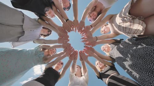 Diverse Group of Women are Forming a Circle with Their Hands Together Outdoors on a Sunny Day