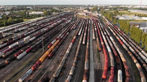 Aerial shot Showing Large Train Depot With Many colorful cargo Trains