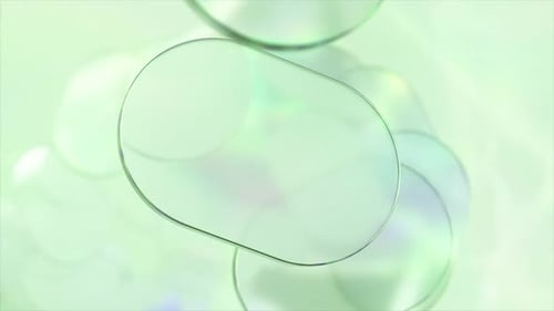 Pastel Green Rounded Oblong Shapes Gently Rotating Against Soft Iridescent Background Creating
