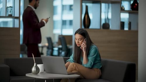 Worried asian businesswoman talking smartphone about project failure at company lobby