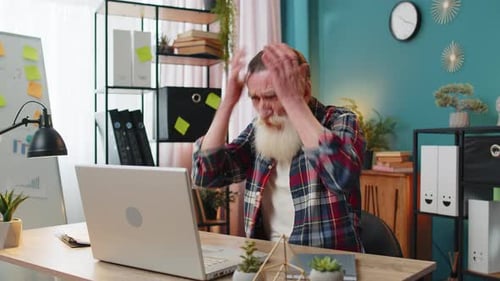 Senior Man Working on Laptop at Home Office