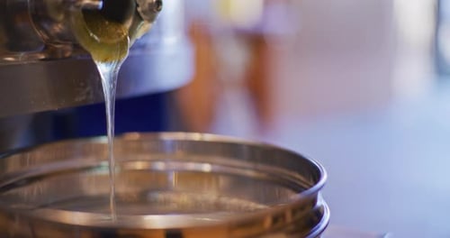 Honey Pouring Into Jar During Production