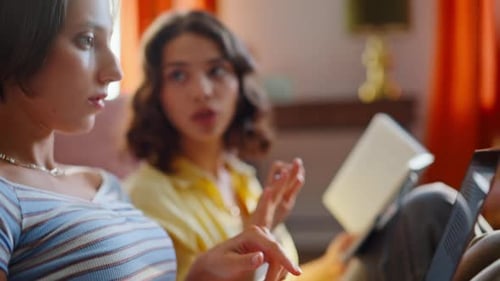 Young Women Collaborating on Laptop at Home