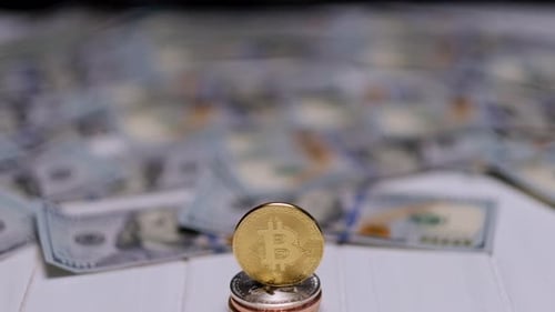 Bitcoin Coin Stacked on Currency with USD Background