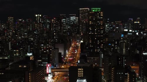 Aerial Ascending Shot of Large City at Night Tall Residential Buildings and Streets in Urban Borough