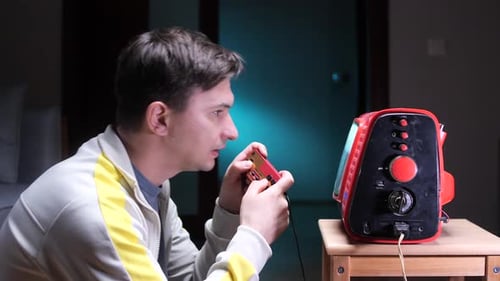 Young Adult Playing Retro Video Game at Home