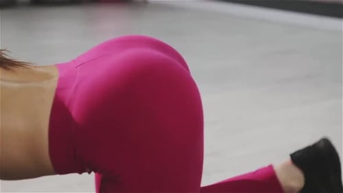 Muscles of a Fit Woman Exercising Kickbacks at Gym