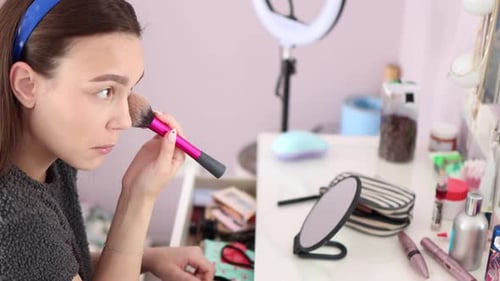 Young Woman Applying Makeup at Home
