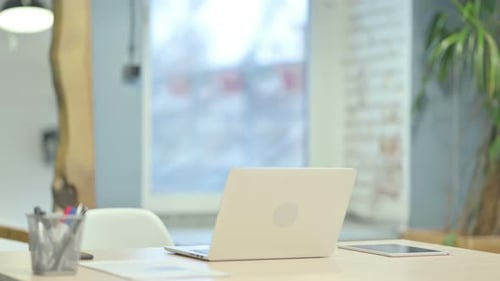 Young Man Coming Back to Office for Work