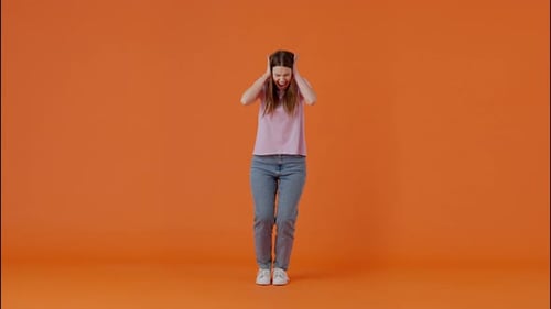 Emotional Female Getting Angry and Grabbing Head in Studio
