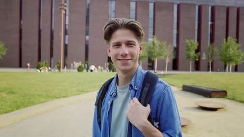 Portrait of male university student standing outside the university campus. Shot with RED helium cam