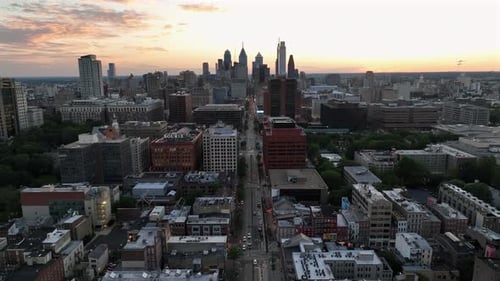 Main Street of America. Metropolis at sunset. Aerial approaching shot. Skyline of downtown it.