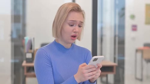 Upset Woman Cries While Holding Smartphone