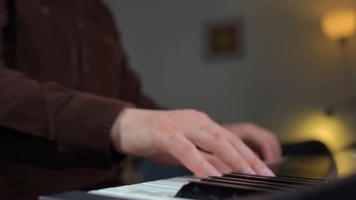 Close-Up of Hands Playing Electronic Keyboard