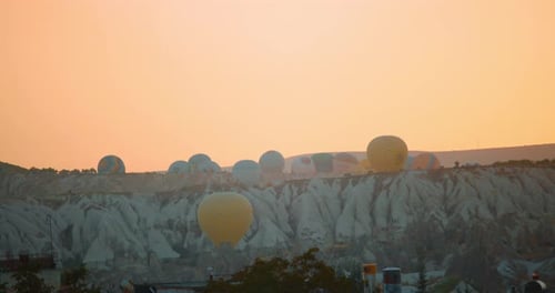 A Captivating View of Hot Air Balloons Rising Over the Unique Landscape of Cappadocia During Sunrise