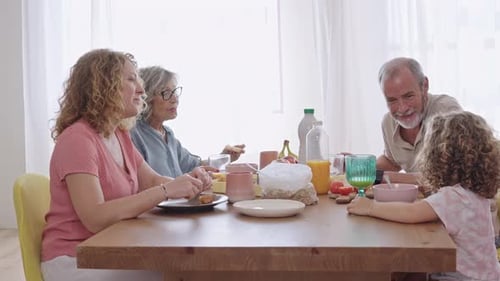 Family Meal Together at Wooden Table in Home