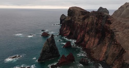 Aerial view of dramatic red cliffs and ocean rock formations along Ponta de São Lourenço, Madeira, P