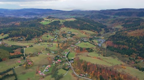 Aerial View of Colorful Autumn Forest Covering Rolling Hills