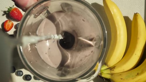 Slowly Pour the Milk Into the Preparing Smoothie with the Blender Running Add More Milk to the