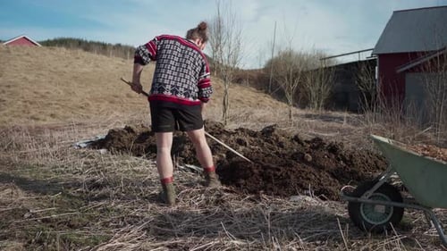 Man Using Rake On Soil Garden - Wide Shot