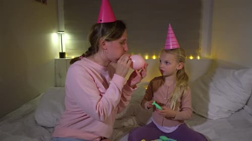 Woman and Child Celebrate Birthday with Balloons Indoors