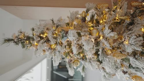 Christmas Tree with Snowy Branches Golden Balls and Glowing Garland