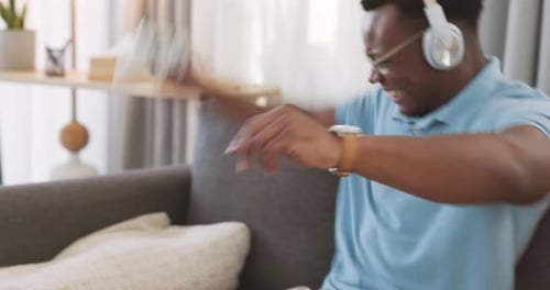 Young Adult Playing Video Game on Couch