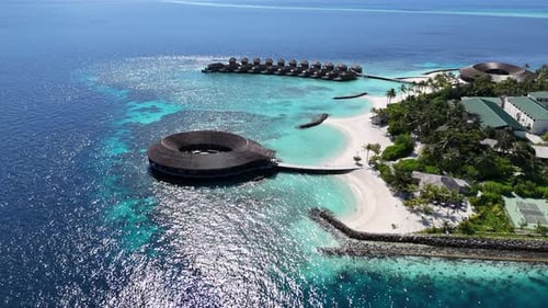 Small hotel on an island surrounded by a coral reef in the Maldives