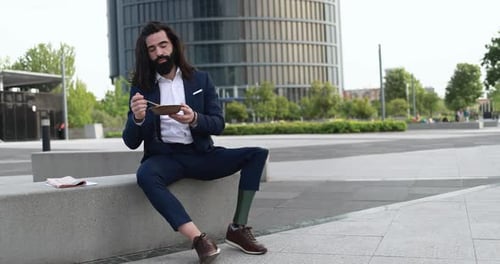 Business Man with Prosthetic Leg Eating Lunch During Break Outdoor From Office