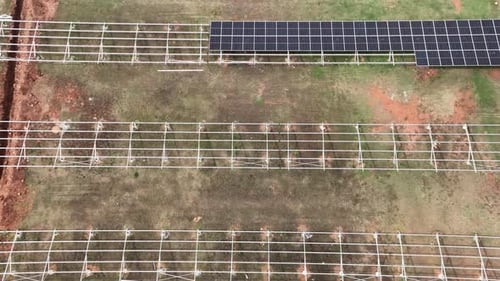 Aerial View of Field with Solar Panels Being Installed