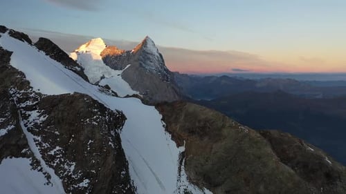 Snow Capped Mountain Peaks at Golden Sunrise