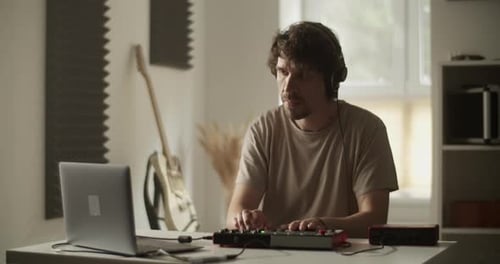 Musician Working On An Electronic Music Creation Board