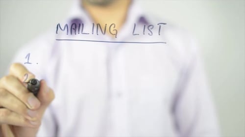 Man Writes Mailing List on Clear Surface