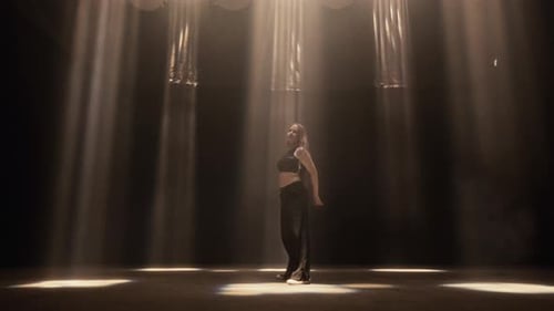 Girl In A Dark Studio Dances Amidst Matrix Beam Lights