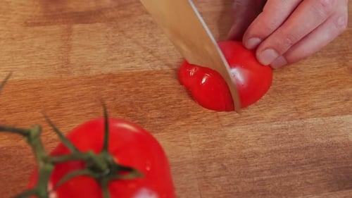 Slicing a Tomato on Cutting Board