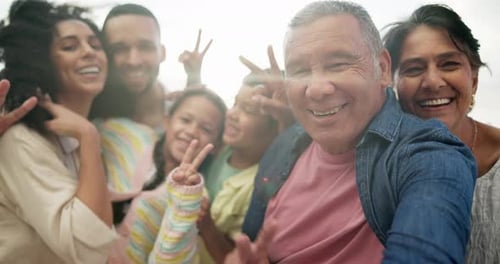 Happy Family Poses for Selfie on Beach
