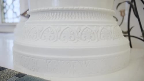 Close up of white beautiful pillar with carved pattern