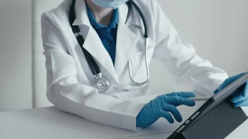 Medical Specialist Works with Focus Behind Touch Tablet Entering Patient Data and Tests for Accurate