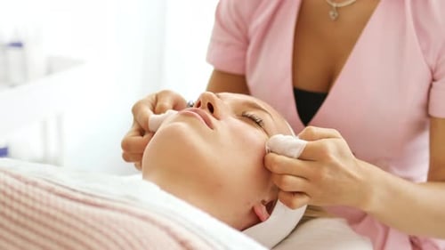 Woman Receiving Facial Treatment at Beauty Clinic