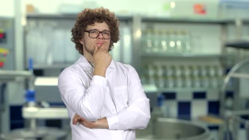 Man in Lab Coat Thinking in Laboratory