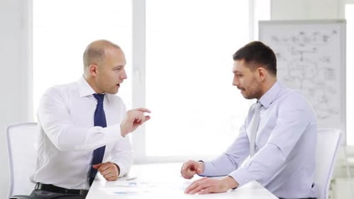 Business, Partnership, Finances and Office Concept - Two Serious Businessmen Holding Papers