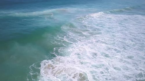 Top down aerial view of the powerful deep blue ocean waves in winter