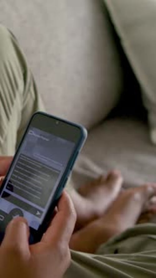 Vertical video: Man scrolling phone on sofa, tapping circle then arrow, browsing app list for tech
