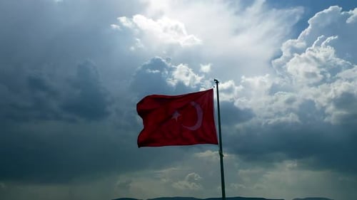 Turkish Flag Waving in Wind Against Cloudy Sky