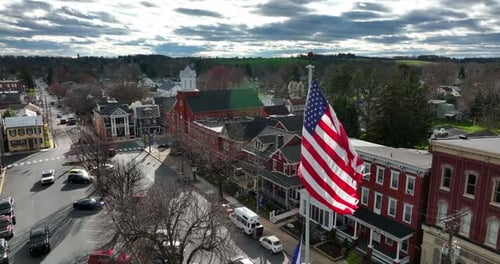 Aerial of American Flag waving in Small Town USA