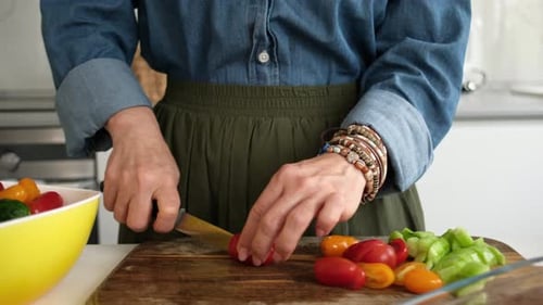 Woman Cutting Tomatoes in Kitchen for Healthy Meal