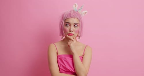 Pensive Woman in Pink Wig and Unicorn Headband