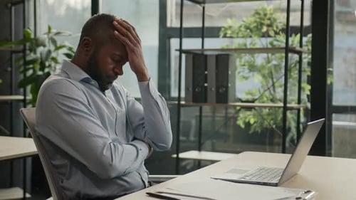 Overworked African American Mature Man Working Laptop in Office Suffer with Eye Strain Exhausted